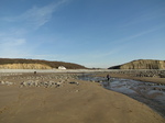 SX17194 Jenni walking through stream on Llantwit Major beach.jpg